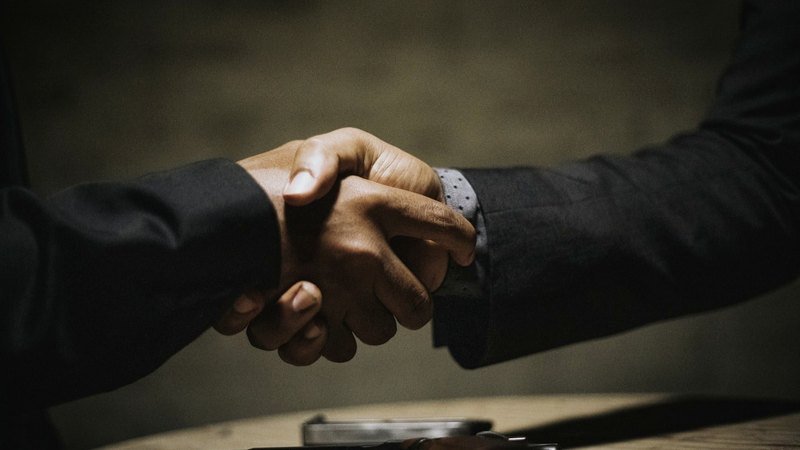Two businessmen shaking hands on a deal
