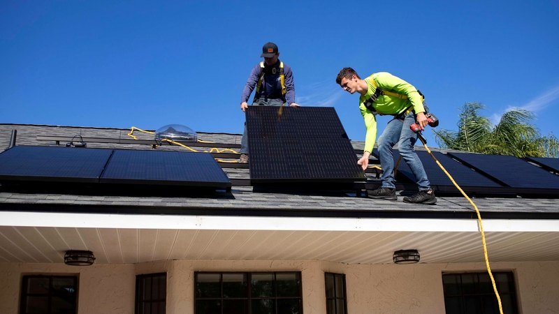 Technicians installing solar panels